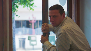 man trying to open a door the wrong way